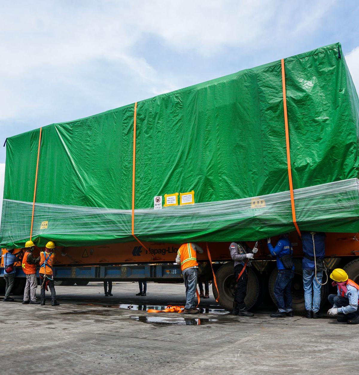 Self-employed crew delivering a large fridge to a home