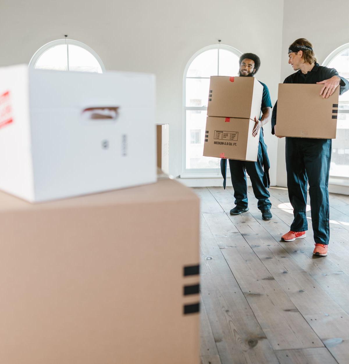 Two-person crew delivering refrigerator into home
