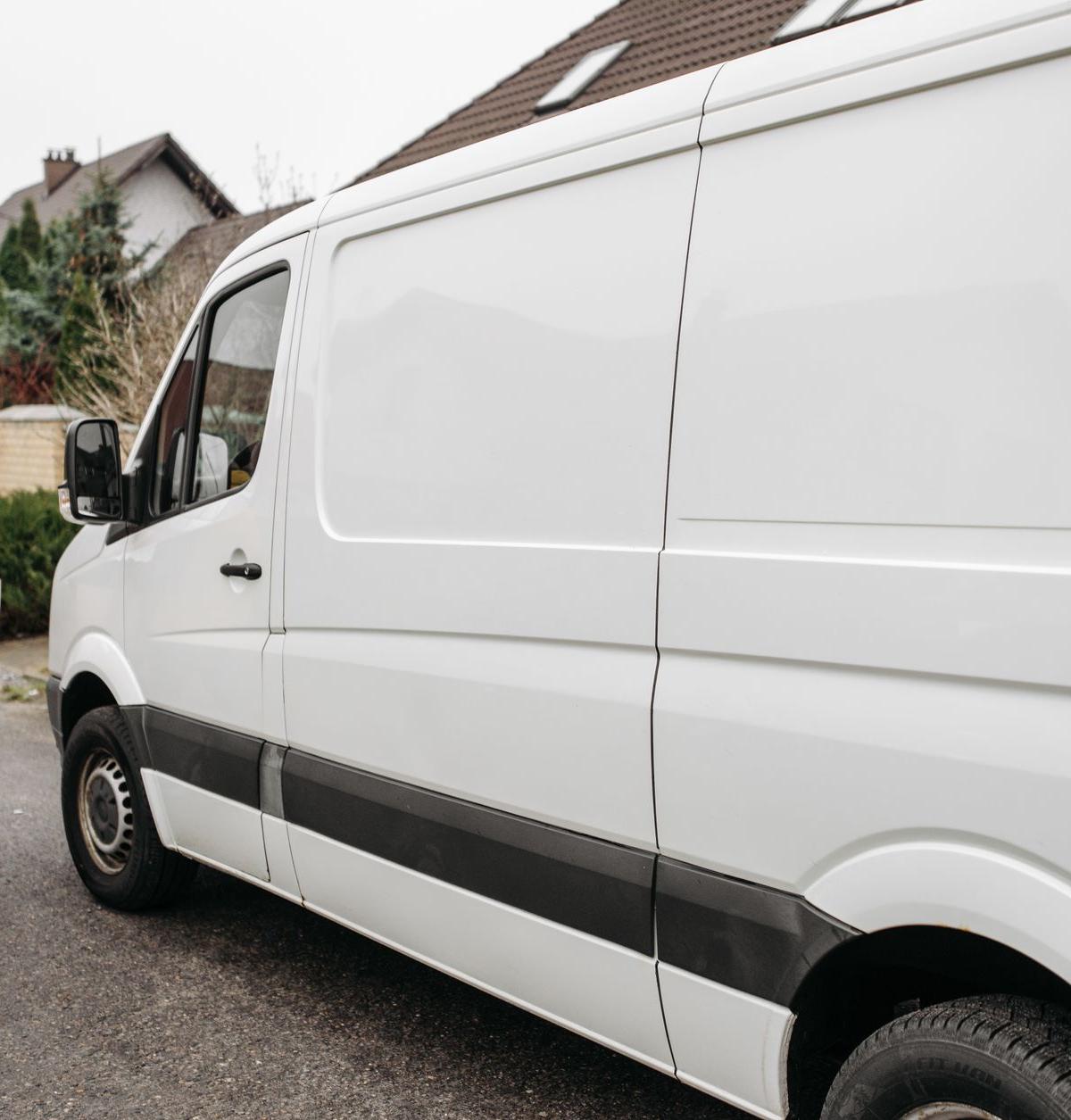 Two-person crew delivering a large fridge into a UK home
