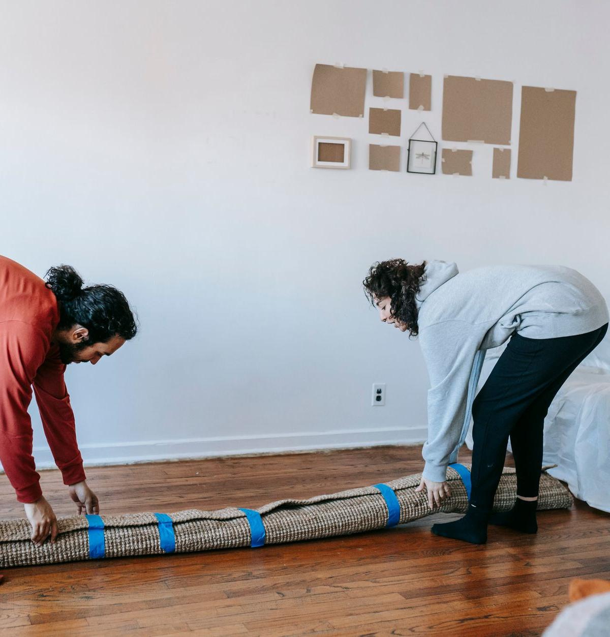 Delivery crew carefully carrying a sofa up a staircase