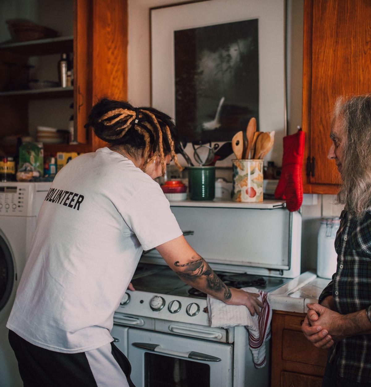 Two-person delivery crew installing a washing machine in a UK home