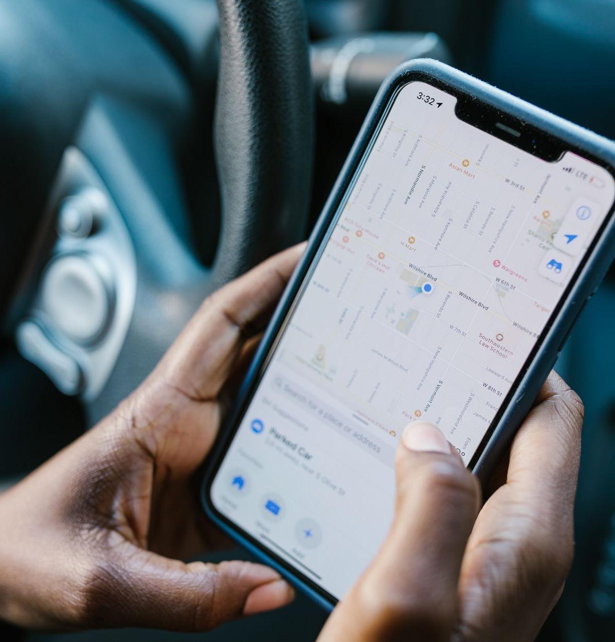 Self-employed drivers consulting a digital map in the cab of a delivery van on a UK street