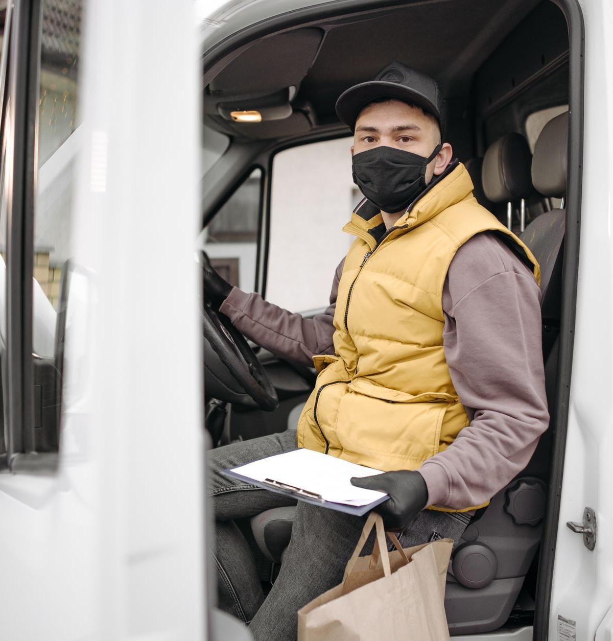 Self-employed delivery driver unloading an appliance