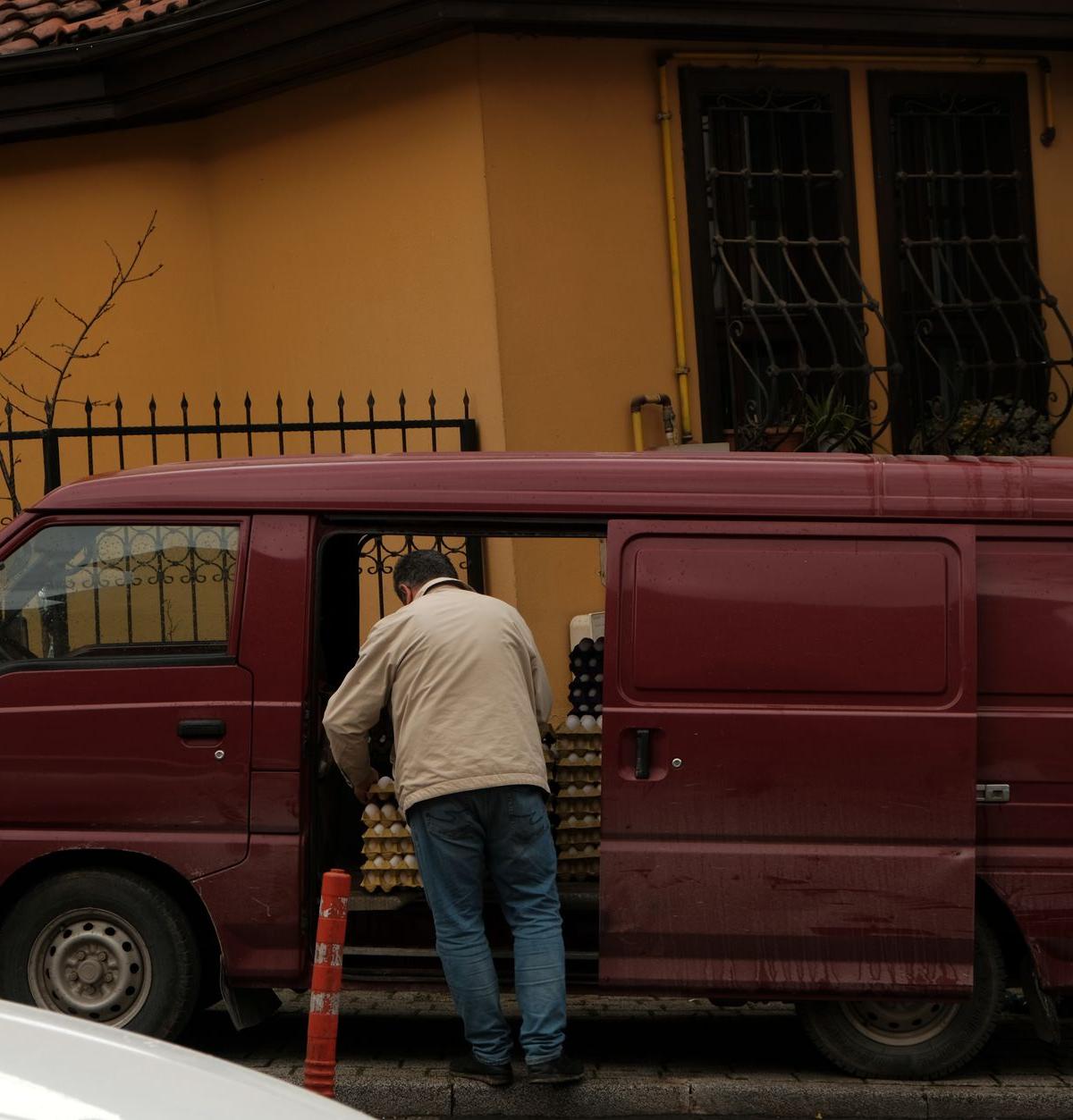 Driver securing furniture in a delivery van