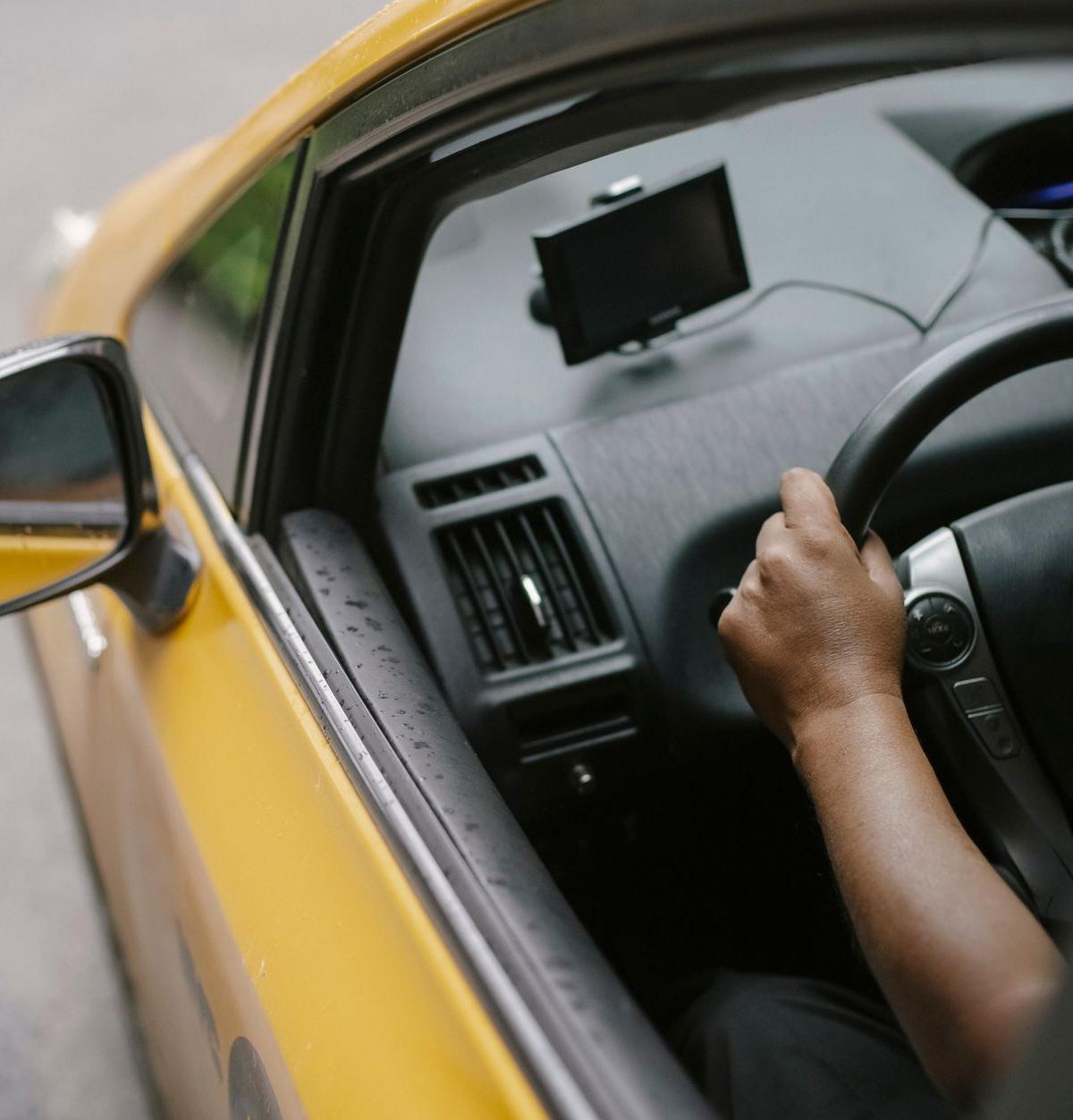 Driver navigating a delivery route using a GPS device
