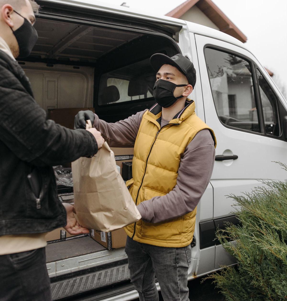 Two-person crew delivering a washing machine into a home