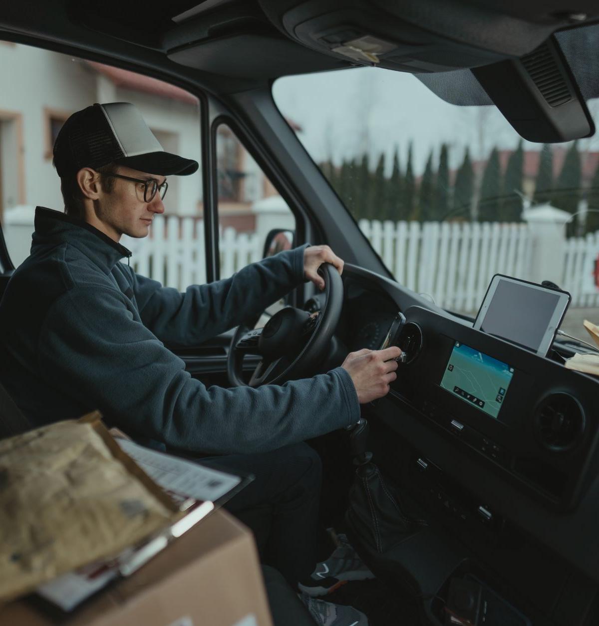 Delivery drivers organising boxes and equipment in the back of a van, capturing the essence of preparation